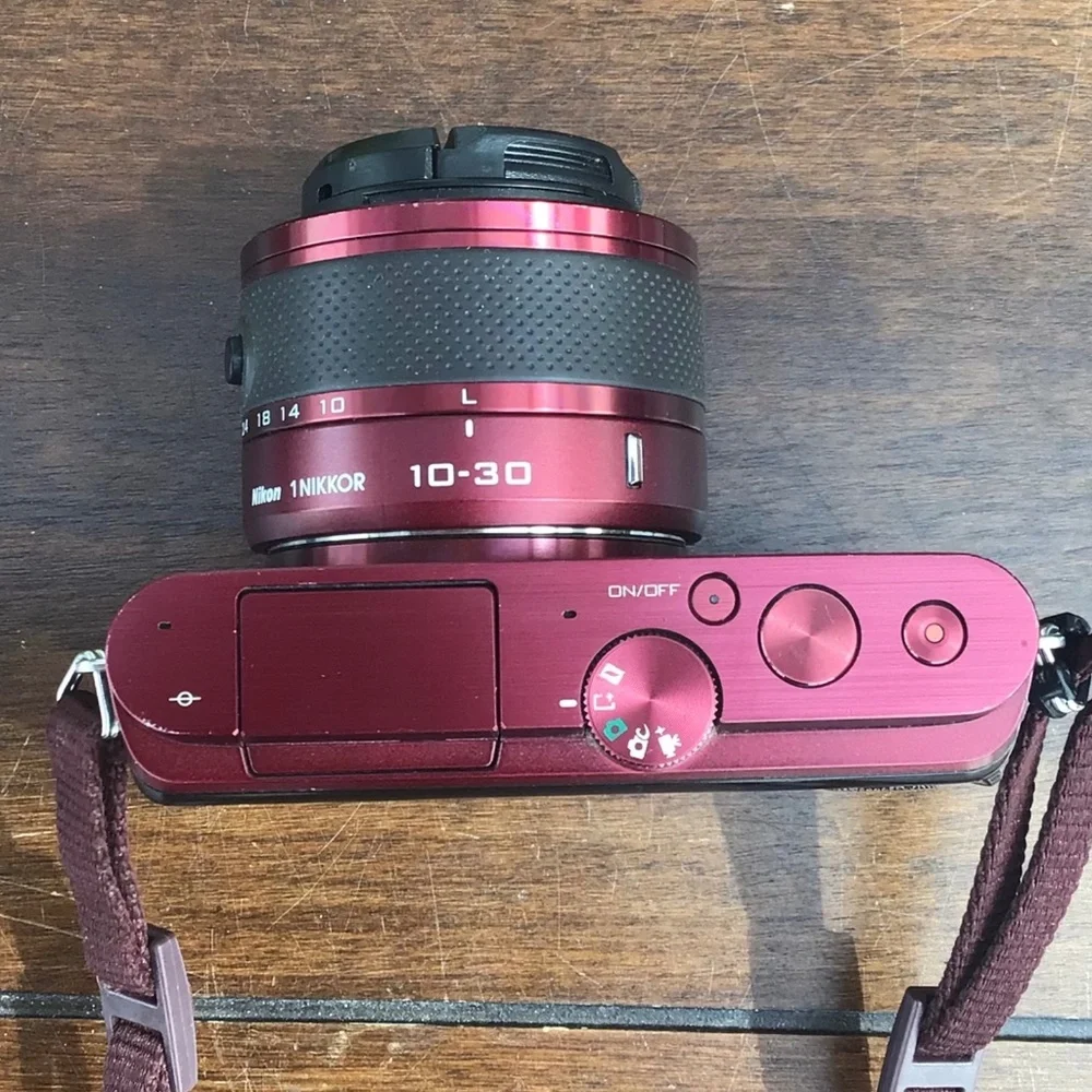 Burgundy Red Nikon 1 J3 high-speed camera with two lenses